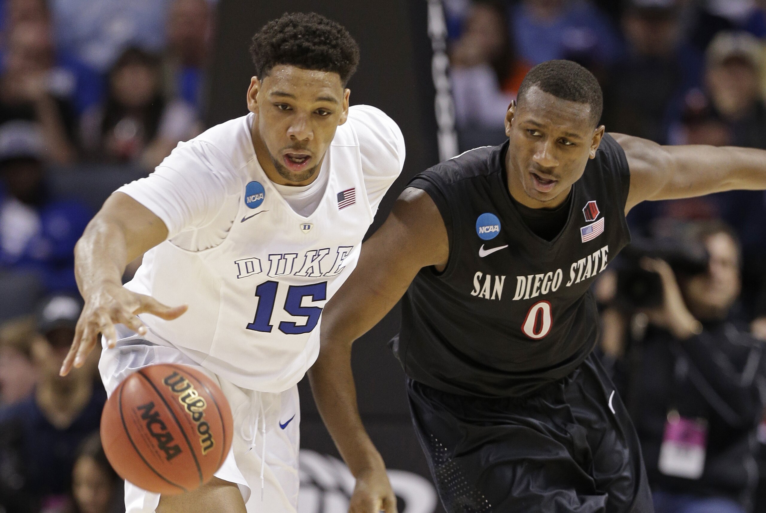 Duke's Jahlil Okafor (15) and San Diego State's Skylar Spencer (0) chase the ball during the second half of an NCAA tournament college basketball game in the Round of 32 in Charlotte, N.C., Sunday, March 22, 2015. (AP Photo/Nell Redmond)