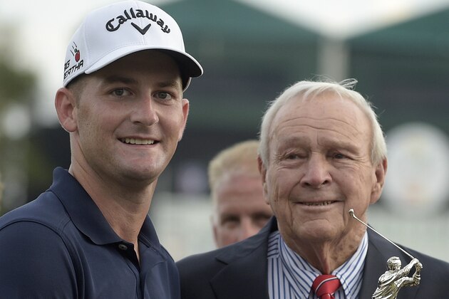 Matt Every, left, is presented the championship trophy by Arnold Palmer after Every won the Arnold Palmer Invitational golf tournament in Orlando, Fla., Sunday, March 22, 2015.(AP Photo/Phelan M. Ebenhack)