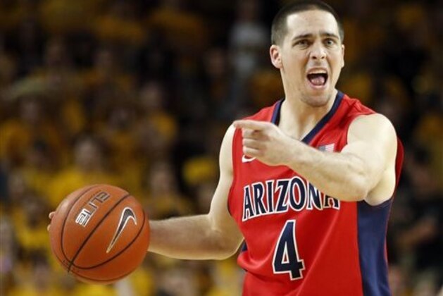 FILE - In this Feb. 7, 2015, file photo, Arizona guard T.J. McConnell directs the offense during the second half of an NCAA college basketball game against Arizona State in Tempe, Ariz. The player who's had the biggest impact on the seventh-ranked Wildcats came without much hype: Point guard T.J. McConnell. (AP Photo/Rick Scuteri, File)