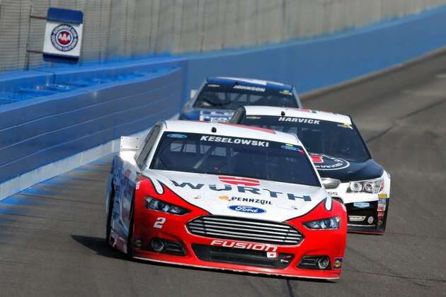 FONTANA, CA - MARCH 22:  Brad Keselowski, driver of the #2 Wurth Ford, leads Kevin Harvick, driver of the #4 Jimmy John's/Budweiser Chevrolet, and Jimmie Johnson, driver of the #48 Lowe's Pro Services Chevrolet, during the NASCAR Sprint Cup Series Auto Club 400 at Auto Club Speedway on March 22, 2015 in Fontana, California.  (Photo by Doug Pensinger/Getty Images)