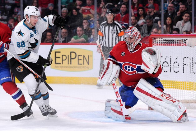 MONTREAL, QC - MARCH 21:  Carey Price #31 of the Montreal Canadiens makes a glove save on the puck in front of Melker Karlsson #68 of the San Jose Sharks during the NHL game at the Bell Centre on March 21, 2015 in Montreal, Quebec, Canada.  (Photo by Richard Wolowicz/Getty Images)