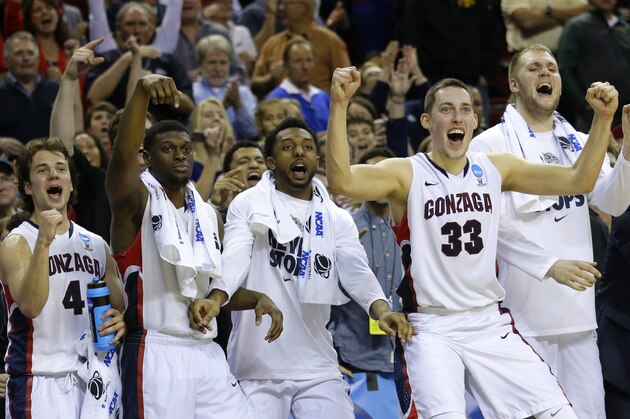 Gonzaga players, including Kyle Wiltjer (33), Przemek Karnowski, right, and Kevin Pangos (4), celebrate in the final seconds of the second half of an NCAA tournament college basketball game in the Round of 32, Sunday, March 22, 2015, in Seattle. Gonzaga beat Iowa 87-68. (AP Photo/Ted S. Warren)