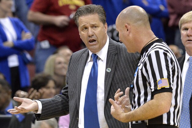 Kentucky head coach John Calipari, left, argues a call with a game official during the second half of an NCAA tournament college basketball game in Louisville, Ky., Saturday, March 21, 2015. (AP Photo/Timothy D. Easley)