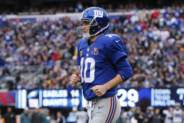 New York Giants' Eli Manning (10) leaves the field during the first half of an NFL football game against the Philadelphia Eagles Sunday, Dec. 28, 2014, in East Rutherford, N.J. The Eagles won the game 34-26. (AP Photo/Julio Cortez)