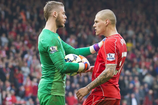 Manchester United's goalkeeper David De Gea, left, tussles with Liverpool's Martin Skrtel during the English Premier League soccer match between Liverpool and Manchester United at Anfield Stadium, Liverpool, England, Sunday, March 22, 2015. (AP Photo/Jon Super)