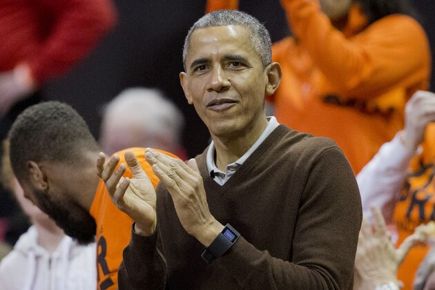 President Barack Obama applauds as he attends a Princeton vs Wisconsin-Green Bay women's college basketball game in the first round of the NCAA tournament in College Park, Md., Saturday, March 21, 2015. Obama's niece Leslie Robinson, plays for Princeton.(AP Photo/Pablo Martinez Monsivais)
