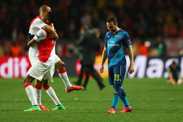 MONACO - MARCH 17:  Santi Cazorla of Arsenal looks dejected as Monaco players celebrate qualifying for the next round after the UEFA Champions League round of 16 second leg match between AS Monaco and Arsenal at Stade Louis II on March 17, 2015 in Monaco, Monaco.  (Photo by Michael Steele/Getty Images)