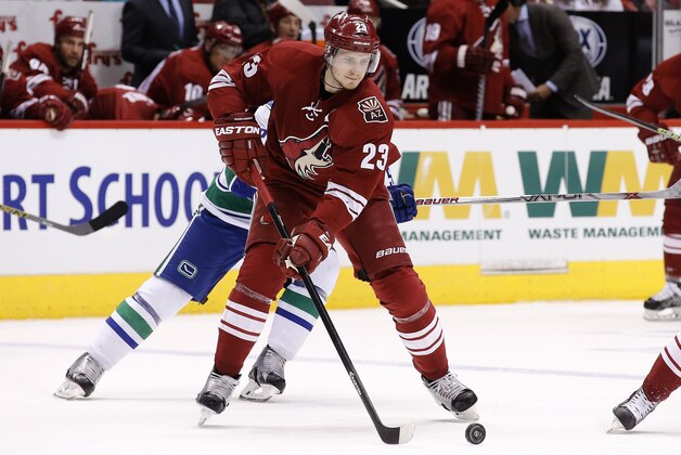 Arizona Coyotes' Oliver Ekman-Larsson, of Sweden, skates with the puck against the Vancouver Canucks during the first period of an NHL hockey game Sunday, March 22, 2015, in Glendale, Ariz. (AP Photo/Ross D. Franklin)