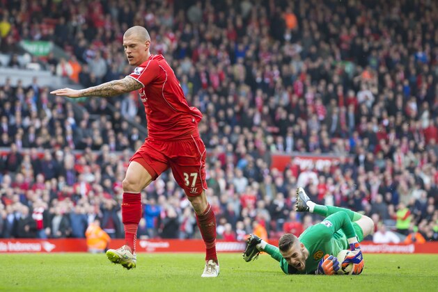 Manchester United's goalkeeper David De Gea, right, reacts after a challenge with Liverpool's Martin Skrtel during the English Premier League soccer match between Liverpool and Manchester United at Anfield Stadium, Liverpool, England, Sunday, March 22, 2015. (AP Photo/Jon Super)
