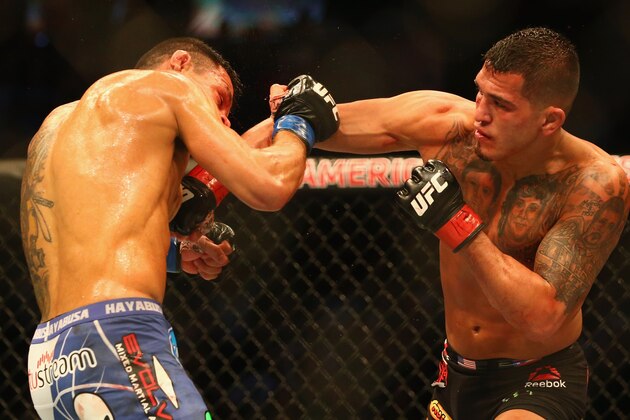 DALLAS, TX - MARCH 14:  (L-R) Rafael dos Anjos fights with Anthony Pettis in the Lightweight Title bout during the UFC 185 event at American Airlines Center on March 14, 2015 in Dallas, Texas.  (Photo by Ronald Martinez/Getty Images)