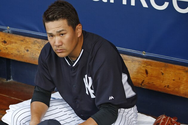 New York Yankees starting pitcher Masahiro Tanaka sits on the dugout bench before starting in his first game since he was shut down with an elbow injury last year in Tampa, Fla., Thursday, March 12, 2015. Tanaka pitched two scoreless innings against the Atlanta Braves. (AP Photo/Kathy Willens)