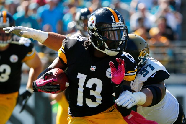 JACKSONVILLE, FL - OCTOBER 05:  Roy Miller #97 of the Jacksonville Jaguars attempts to tackle  Dri Archer #13 of the Pittsburgh Steelers during the game at EverBank Field on October 5, 2014 in Jacksonville, Florida.  (Photo by Sam Greenwood/Getty Images)