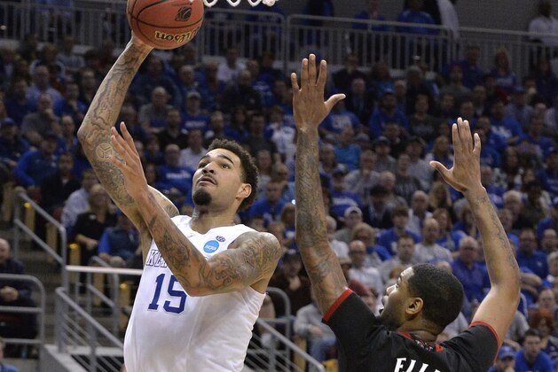 Kentucky's Willie Cauley-Stein, left, goes up for a shot past the defense of Cincinnati's Octavius Ellis during the second half of an NCAA tournament college basketball game in Louisville, Ky., Saturday, March 21, 2015. (AP Photo/Timothy D. Easley)