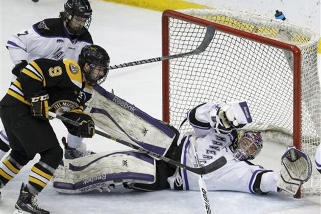 Minnesota State Mankato goalie Stephon Williams, right, dives to stop a shot in front of Michigan Tech forward Alex Gillies (9) and Minnesota State Mankato defenseman Zach Palmquist (7) during the first period of the WCHA Final Five college championship hockey game in St. Paul, Minn., Saturday, March 21, 2015. (AP Photo/Ann Heisenfelt)