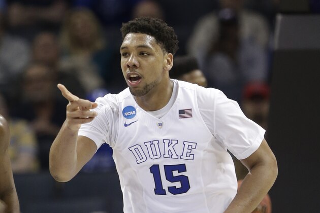 Duke's Jahlil Okafor (15) points to a teammate after a basket against San Diego State during the second half of an NCAA tournament college basketball game in the Round of 32 in Charlotte, N.C., Sunday, March 22, 2015. Duke won 68-49. (AP Photo/Gerald Herbert)