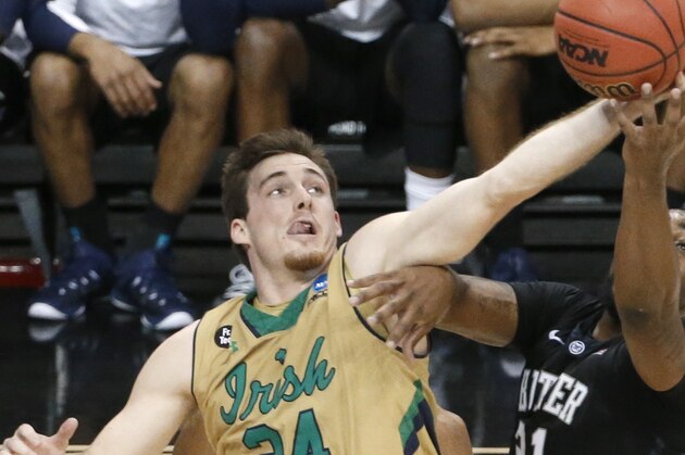 Notre Dame's Pat Connaughton (24) grabs the ball from Butler's Roosevelt Jones (21) during the second half of an NCAA college basketball tournament Round of 32 game Saturday, March 21, 2015, in Pittsburgh. (AP Photo/Gene J. Puskar)