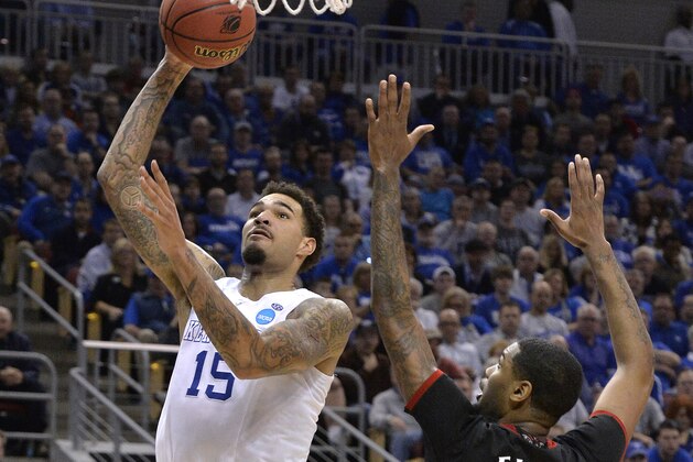 Kentucky's Willie Cauley-Stein, left, goes up for a shot past the defense of Cincinnati's Octavius Ellis during the second half of an NCAA tournament college basketball game in Louisville, Ky., Saturday, March 21, 2015. (AP Photo/Timothy D. Easley)