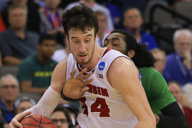 Oregon's Dwayne Benjamin, rear, tries to steal the ball from Wisconsin's Frank Kaminsky (44) during the second half of an NCAA tournament college basketball game in the Round of 32 in Omaha, Neb., Sunday, March 22, 2015. Wisconsin won 72-65. (AP Photo/Nati Harnik)