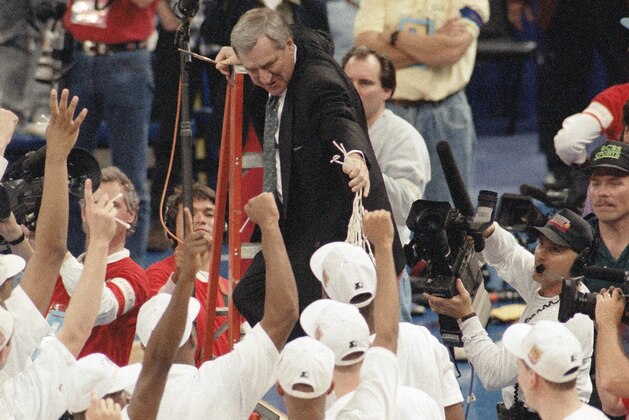 North Carolina coach Dean Smith hands the net to his players after the Tar Heels beat Michigan 77-71 to win the NCAA in New Orleans, April 6, 1993.  (AP Photo/Bob Jordan)