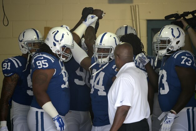 Indianapolis Colts defensive players Jonathan Newsome (91), Montori Hughes (95), Zach Kerr (94) and Kelcy Quarles (73) huddle together in the tunnel before heading out for warmups prior to an NFL football game against the Jacksonville Jaguars in Jacksonville, Fla., Sunday, Sept. 21, 2014. (AP Photo/Phelan M. Ebenhack)