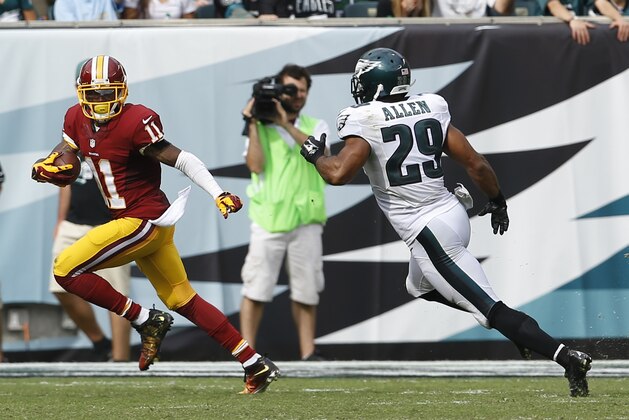 Washington Redskins wide receiver DeSean Jackson (11) looks back as Philadelphia Eagles strong safety Nate Allen (29) chases after him on a scoring reception during the second half of an NFL football game, Sunday, Sept. 21, 2014, in Philadelphia. (AP Photo/Michael Perez)