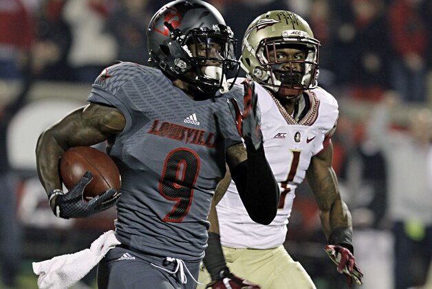 Louisville wide receiver DeVante Parker (9) outruns would-be tackler Tyler Hunter (1) after making this pass reception in their NCAA college football game in Louisville, Ky., Thursday, Oct. 30, 2014. (AP Photo/Garry Jones)