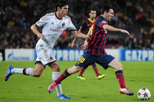 Barcelona's Lionel Messi drives the ball  while being chased by AC Milan's Kaka during the  Champions League group H soccer match between FC Barcelona and AC Milan, at the Camp Nou stadium, in Barcelona, Spain, Wednesday, Nov. 6, 2013. (AP Photo/Manu Fernandez)