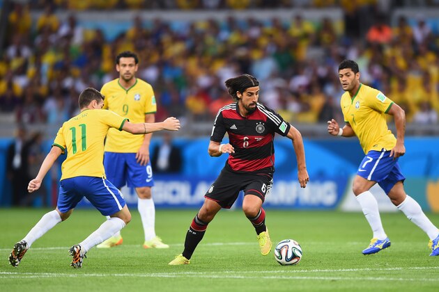 BELO HORIZONTE, BRAZIL - JULY 08:  Sami Khedira (C) of Germany runs past Oscar (L) of Brazil with the ball during the 2014 FIFA World Cup Brazil Semi Final match between Brazil and Germany at Estadio Mineirao on July 8, 2014 in Belo Horizonte, Brazil.  (Photo by Laurence Griffiths/Getty Images)