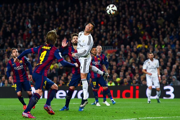 BARCELONA, SPAIN - MARCH 22:  Cristiano Ronaldo of Real Madrid CF heads the ball towards goal during the La Liga match Between FC Barcelona and Real Madrid CF at Camp Nou on March 22, 2015 in Barcelona, Spain.  (Photo by David Ramos/Getty Images)