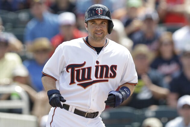 Minnesota Twins second baseman Brian Dozier (2) heads to the dugout after scoring in the second inning during an exhibition spring training baseball game against the Tampa Bay Rays, Wednesday, March 11, 2015, in Fort Myers Fla. (AP Photo/Brynn Anderson)