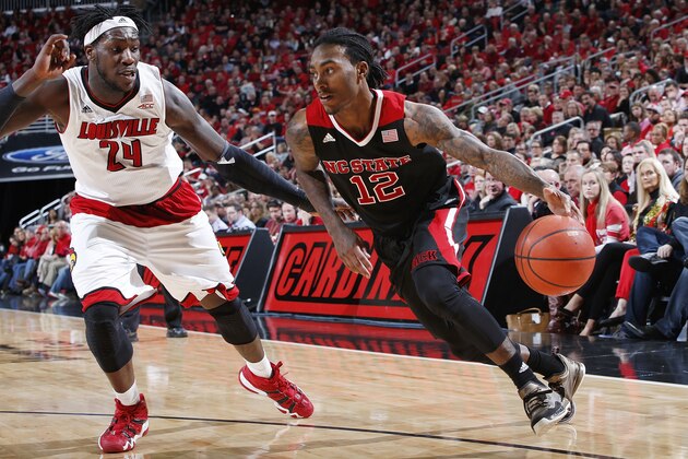 LOUISVILLE, KY - FEBRUARY 14: Anthony Barber #12 of the North Carolina State Wolfpack drives to the basket against Montrezl Harrell #24 of the Louisville Cardinals during the game at KFC Yum! Center on February 14, 2015 in Louisville, Kentucky. North Carolina State defeated Louisville 74-65. (Photo by Joe Robbins/Getty Images)