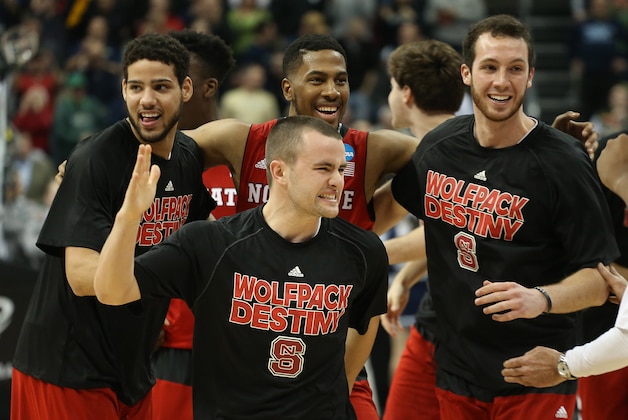 Mar 21, 2015; Pittsburgh, PA, USA; The North Carolina State Wolfpack players celebrate after defeating the Villanova Wildcats 71-68 in the third round of the 2015 NCAA Tournament at Consol Energy Center. The Wolfpack won 71-68. Mandatory Credit: Charles LeClaire-USA TODAY Sports
