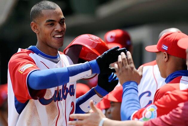 MEXICO CITY - MARCH 08:  Hector Olivera #28 of Cuba is congratulated by his teammates after hitting a home run against South Africa during the 2009 World Baseball Classic Pool B match on March 8, 2009 at the Estadio Foro Sol in Mexico City, Mexico.  (Photo by Kevork Djansezian/Getty Images)