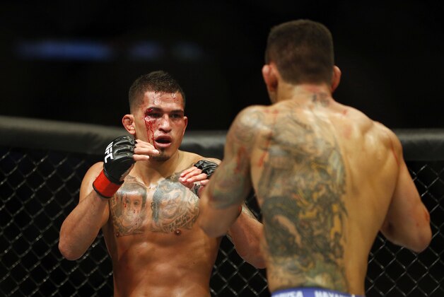 Mar 14, 2015; Dallas, TX, USA; Anthony Pettis (red) fights Rafael dos Anjos (blue) in the lightweight title bout during UFC 185 at American Airlines Center. Mandatory Credit: Tim Heitman-USA TODAY Sports
