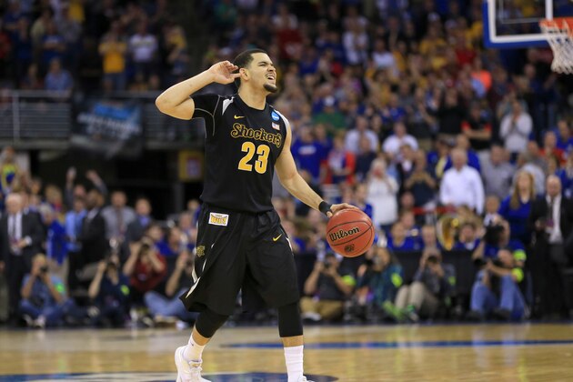 Wichita State's Fred VanVleet (23) turns to fans near the end of an NCAA tournament college basketball game against Kansas, in the Round of 32 in Omaha, Neb., Sunday, March 22, 2015. Wichita State won 78-65. (AP Photo/Nati Harnik)