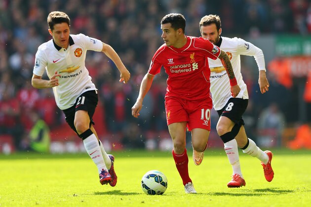 LIVERPOOL, ENGLAND - MARCH 22: Philippe Coutinho of Liverpool goes past Ander Herrera (L) and Juan Mata of Manchester United during the Barclays Premier League match between Liverpool and Manchester United at Anfield on March 22, 2015 in Liverpool, England.  (Photo by Alex Livesey/Getty Images)