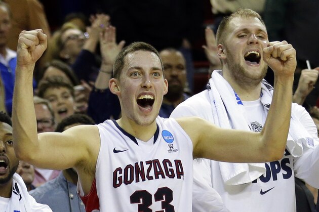 Gonzaga's Kyle Wiltjer (33) and Przemek Karnowski, right, celebrate in the final seconds of the second half of an NCAA tournament college basketball game against Iowa in the Round of 32, Sunday, March 22, 2015, in Seattle. Gonzaga beat Iowa 87-68. (AP Photo/Ted S. Warren)