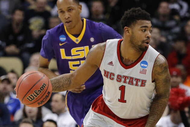 North Carolina State's Trevor Lacey (1) tries to get around LSU's Tim Quarterman during the first half of an NCAA tournament second round college basketball game, Thursday, March 19, 2015, in Pittsburgh. (AP Photo/Keith Srakocic)