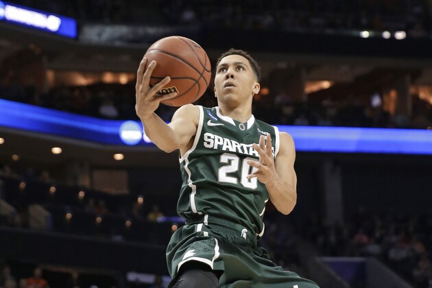 Michigan State's Travis Trice (20) drives to the basket against Virginia during the first half of an NCAA tournament college basketball game in the Round of 32 in Charlotte, N.C., Sunday, March 22, 2015. (AP Photo/Gerald Herbert)