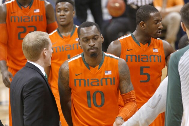 Miami's Sheldon McClellan (10), Davon Reed (5), Deandre Burnett (1) and Tonye Jekiri (23) walk to the bench during a timeout in the second half of an NCAA college basketball game against Pittsburgh, Wednesday, March 4, 2015, in Pittsburgh. Miami won 67-63. (AP Photo/Keith Srakocic)