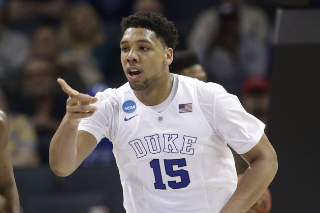 Duke's Jahlil Okafor (15) points to a teammate after a basket against San Diego State during the second half of an NCAA tournament college basketball game in the Round of 32 in Charlotte, N.C., Sunday, March 22, 2015. Duke won 68-49. (AP Photo/Gerald Herbert)