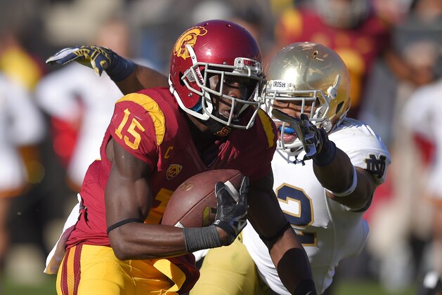Southern California wide receiver Nelson Agholor, left, runs in for a touchdown as Notre Dame safety Elijah Shumate attempt to tackle him during the first half of an NCAA college football game, Saturday, Nov. 29, 2014, in Los Angeles. (AP Photo/Mark J. Terrill)