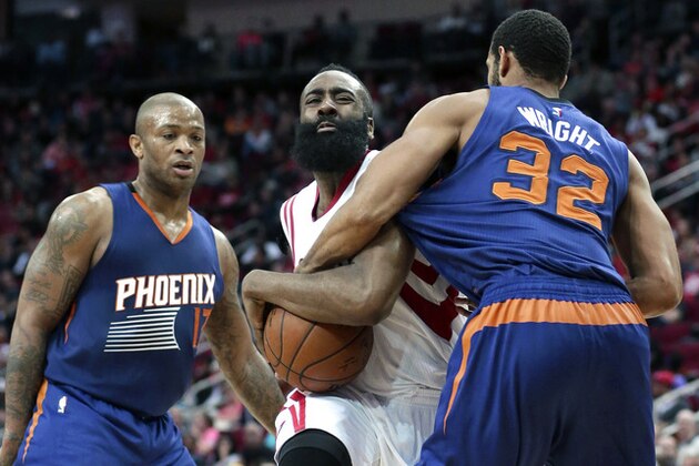 Phoenix Suns' Brandan Wright (32) tries to grab the ball from Houston Rockets' James Harden, center, as P.J. Tucker (17) looks on in the second half of an NBA basketball game Saturday, March 21, 2015, in Houston. The Suns won 117-102. (AP Photo/Pat Sullivan)