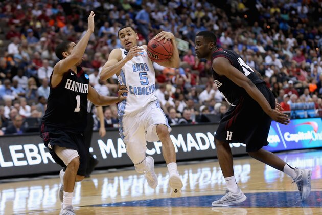 JACKSONVILLE, FL - MARCH 19:  Siyani Chambers #1 of the Harvard Crimson tries to stop Marcus Paige #5 of the North Carolina Tar Heels as he drives to the basket during the second round of the 2015 NCAA Men's Basketball Tournament at Jacksonville Veterans Memorial Arena on March 19, 2015 in Jacksonville, Florida.  (Photo by Mike Ehrmann/Getty Images)