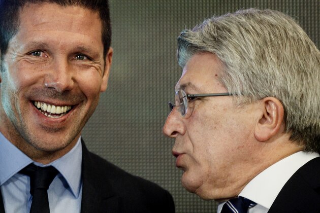 Atletico Madrid coach Diego Simeone, left, smiles while Atletico de Madrid president Enrique Cerezo speaks with him after a press conference at the Vicente Calderon stadium in Madrid, Spain, Tuesday, March 24, 2015. The former Argentina and Atletico midfielder, who took over as coach in December 2011, has renewed his contract with the Spanish champions for another five seasons, keeping him at the club until 2020. (AP Photo/Daniel Ochoa de Olza)