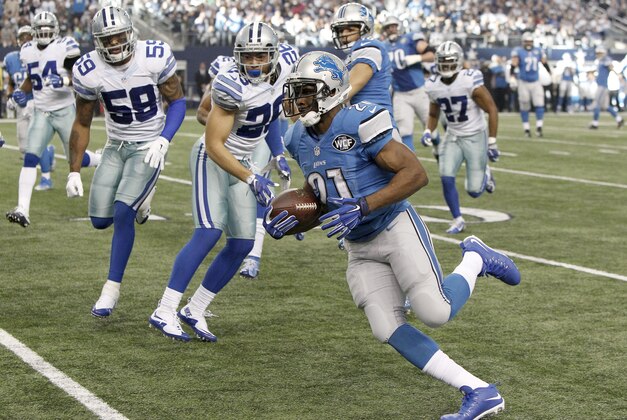 Detroit Lions running back Reggie Bush (21) runs in a touchdown against the Dallas Cowboys during the first half of an NFL wildcard playoff football game, Sunday, Jan. 4, 2015, in Arlington, Texas. (AP Photo/Brandon Wade)