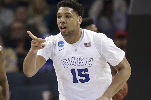 Duke's Jahlil Okafor (15) points to a teammate after a basket against San Diego State during the second half of an NCAA tournament college basketball game in the Round of 32 in Charlotte, N.C., Sunday, March 22, 2015. Duke won 68-49. (AP Photo/Gerald Herbert)