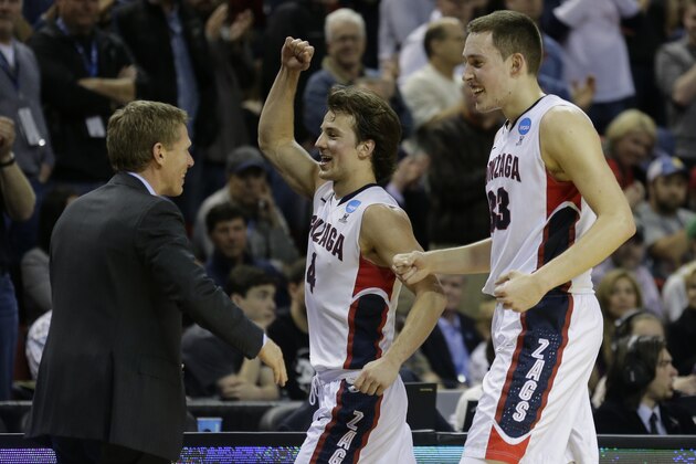 Gonzaga's Kyle Wiltjer, right, and Kevin Pangos, celebrate with Gonzaga head coach Mark Few, left, late in the second half of an NCAA tournament college basketball game against Iowa in the Round of 32, Sunday, March 22, 2015, in Seattle. (AP Photo/Ted S. Warren)