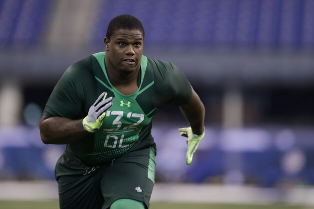 UCLA defensive lineman Ellis Mccarthy runs a drill at the NFL football scouting combine in Indianapolis, Sunday, Feb. 22, 2015. (AP Photo/Julio Cortez)