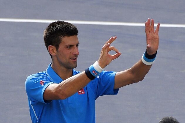 Novak Djokovic, of Serbia, gestures the number 50 with his hands after his 6-3, 6-7 (5), 6-2 win over Roger Federer, of Switzerland, in the men's final at the BNP Paribas Open tennis tournament, Sunday, March 22, 2015, in Indian Wells, Calif. This is Djokovic's 50th career ATP Tour title. (AP Photo/Mark J. Terrill)